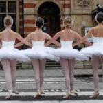Four English National Ballet dancers from Swan Lake cross the street during a photo call in London